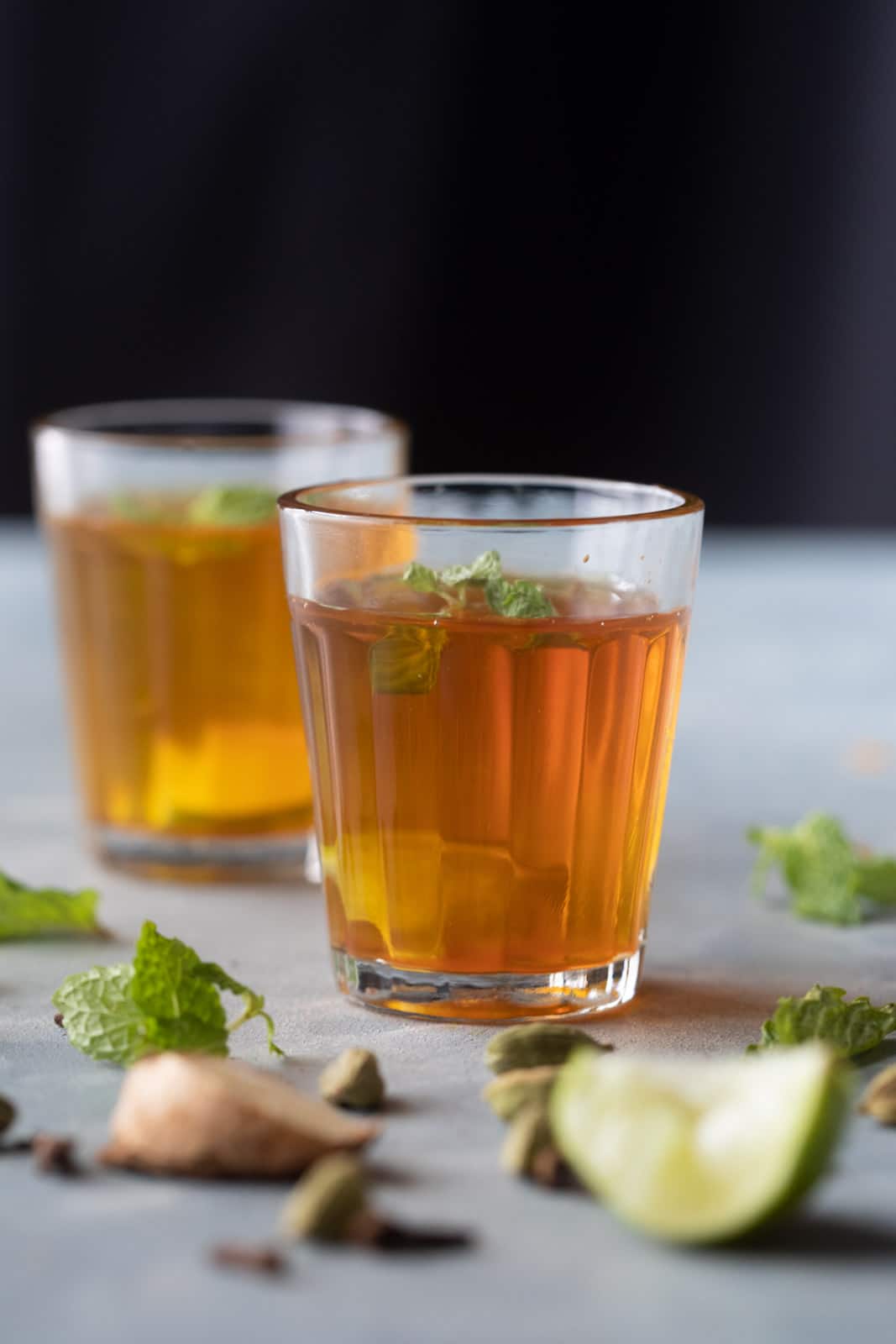 Sulaimani Chai served in small chai glasses with mint and lemon