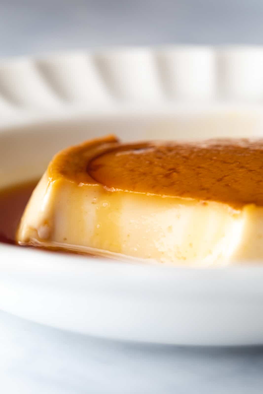 Closeup of the texture of coconut caramel custard after taking a bite