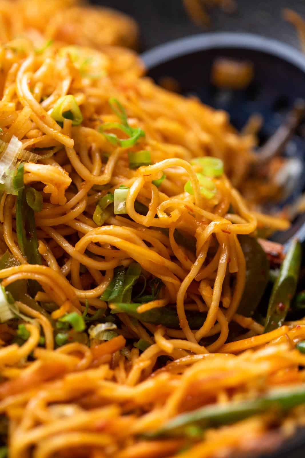 Closeup of chilli garlic noodles in a wok