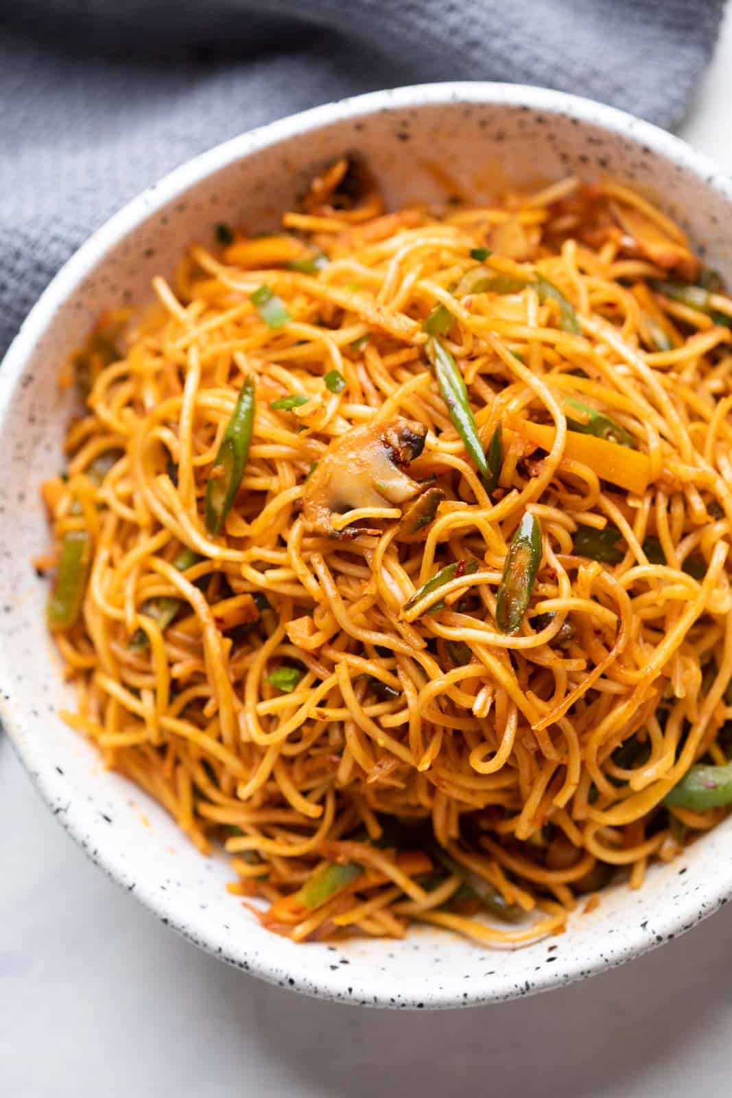Chilli Garlic noodles served in a white textured bowl