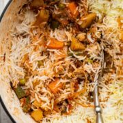 Closeup of veg biryani in the pot after a few spoonfuls have been served