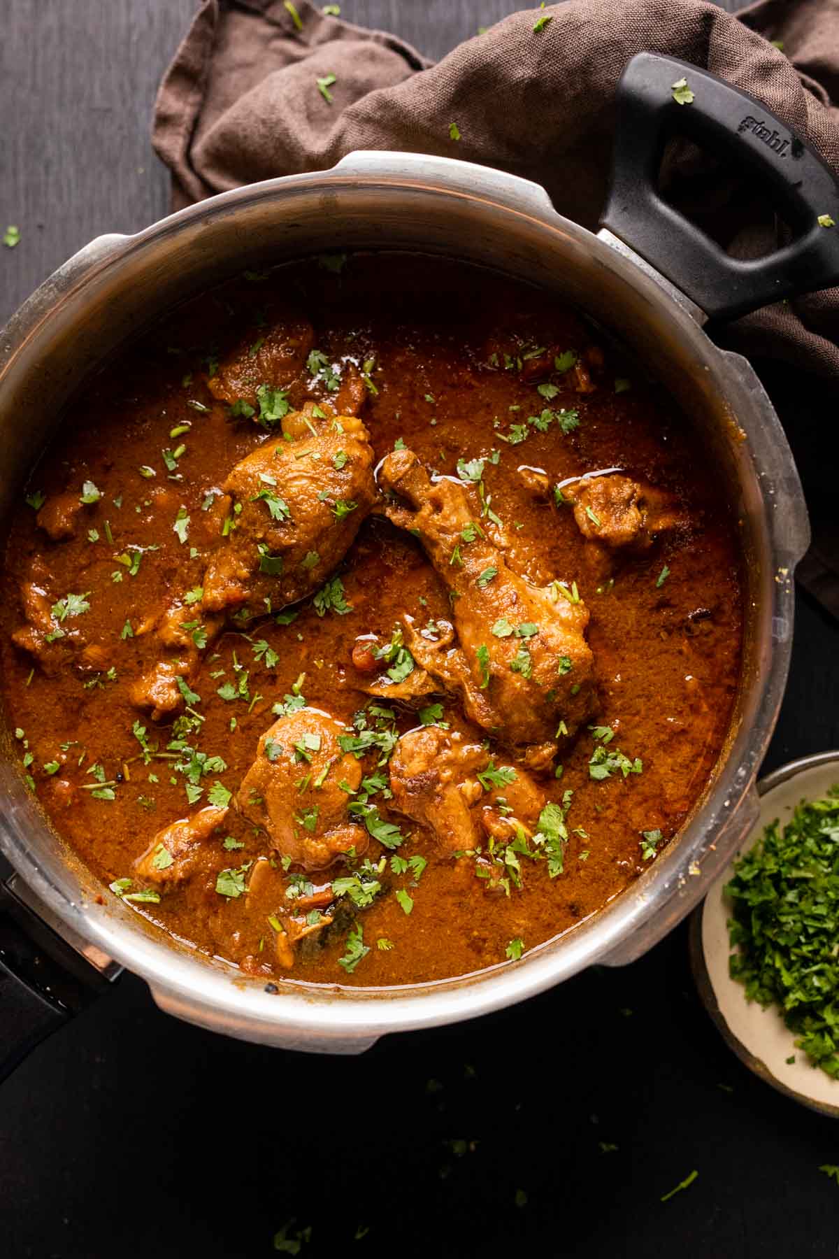 Dhaba style chicken curry served in the pressure cooker it was made in