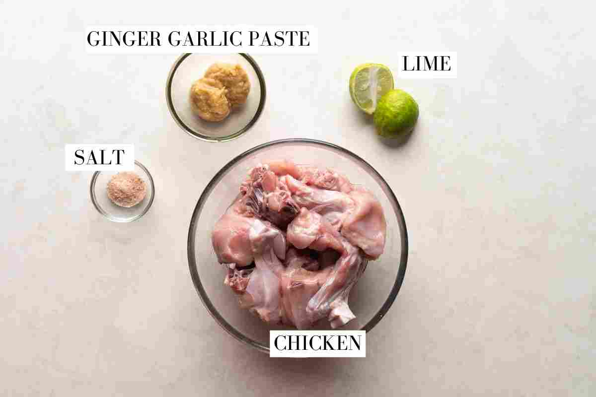 Ingredients for the marinade pictured on white marble with text to identify them