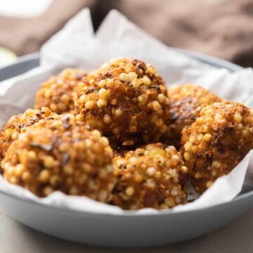 Closeup of sabudana vada bombs stuffed with paneer stacked on top of one another