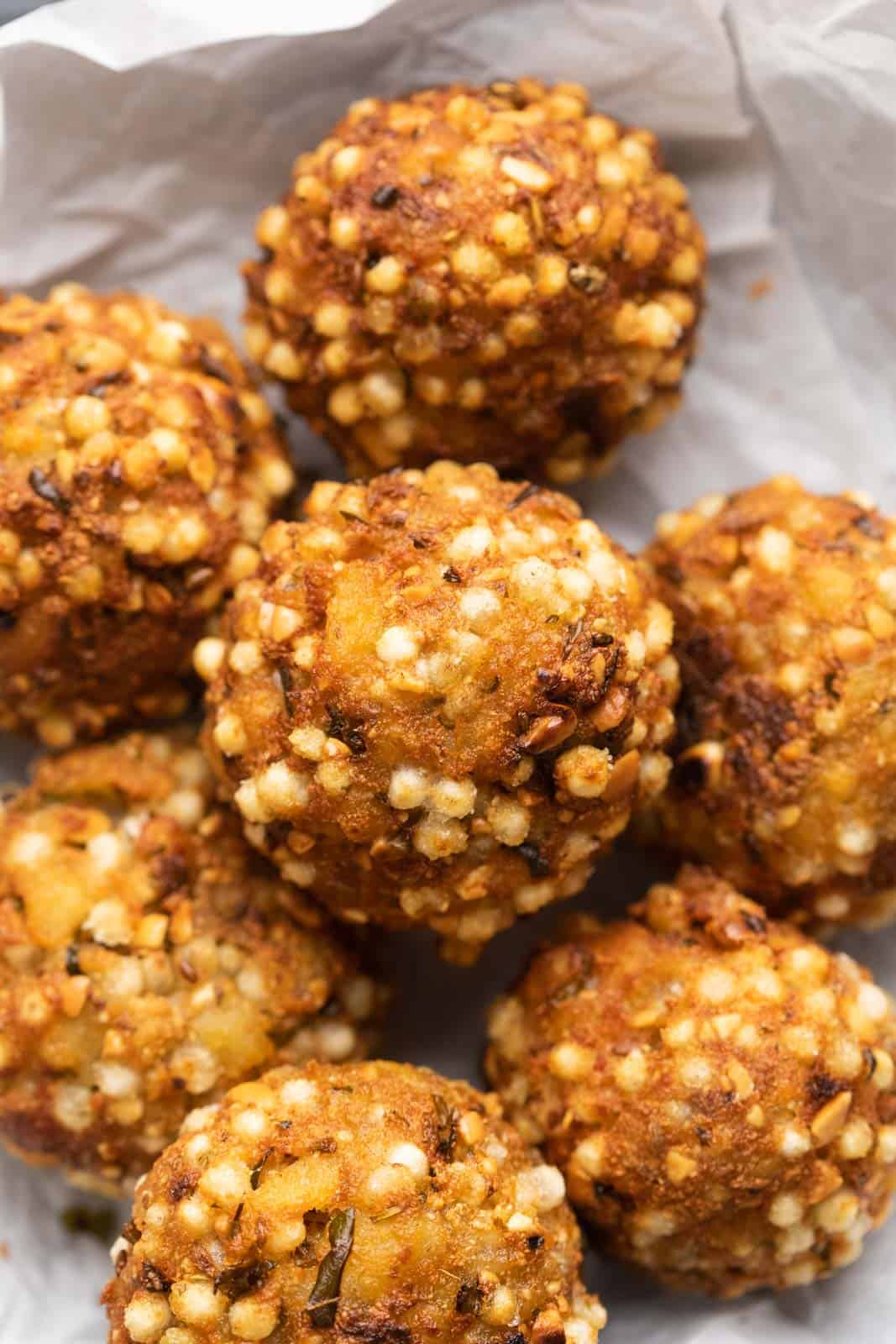 Closeup of sabudana vada bombs stuffed with paneer stacked on top of one another