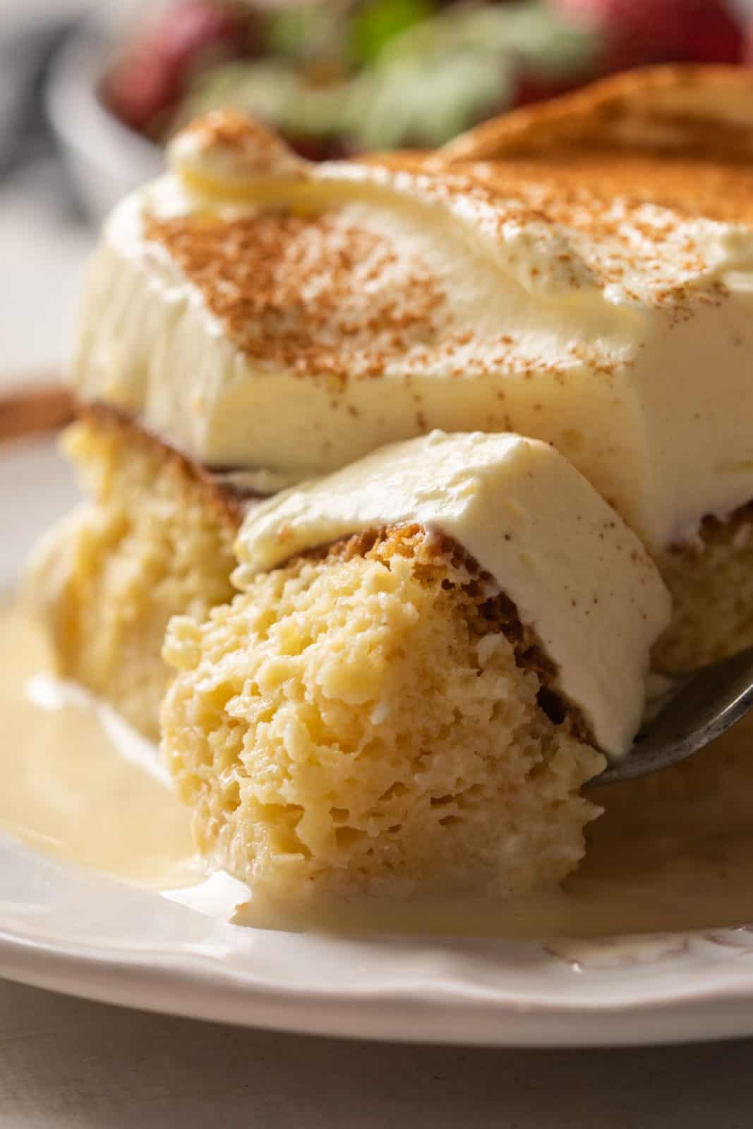 Closeup of a bite of eggnog tres leches to show how moist it is