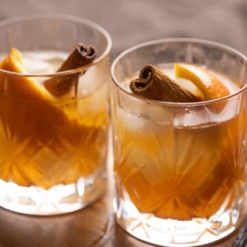 Two glasses of vanilla cinnamon old fashioned served side by side