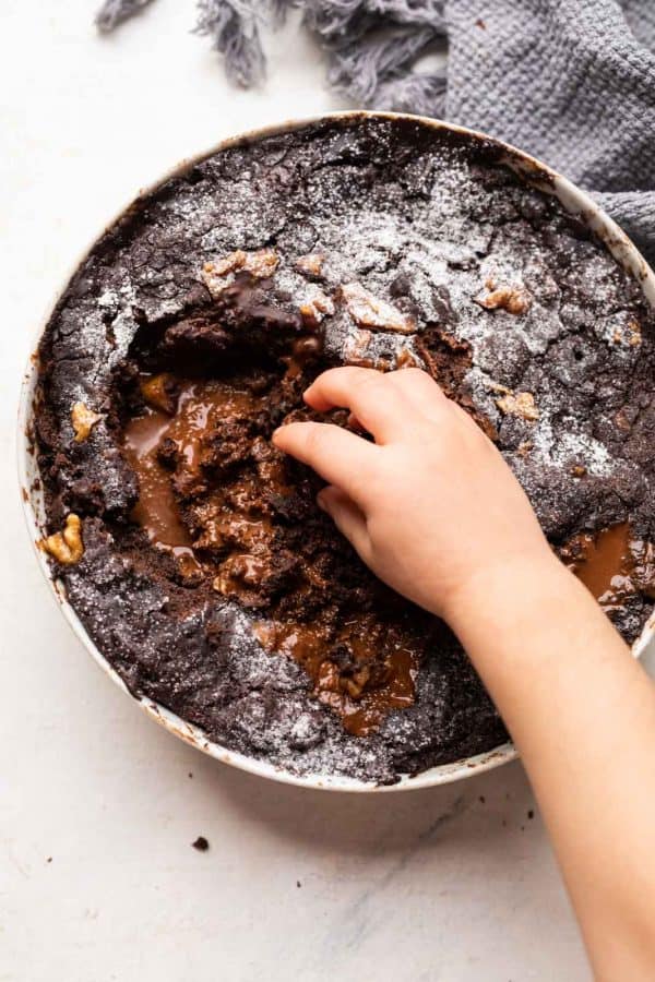 My daughter reaching for the chocolate pudding cake