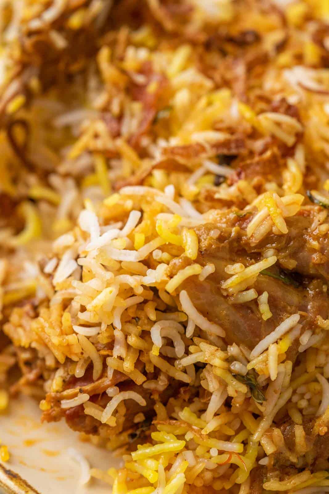 Closeup of the grains of rice and a piece of mutton from the mutton biryani