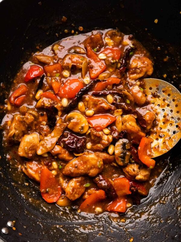 Kung Pao chicken pictures in the wok that it was cooked in with a skimmer