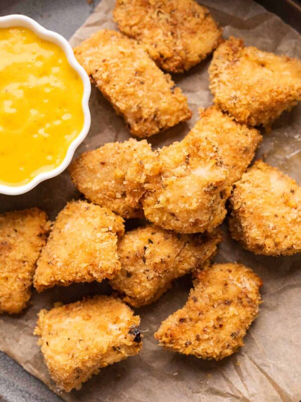 Chicken Nuggets served on a plate with a mango mustard dipping sauce
