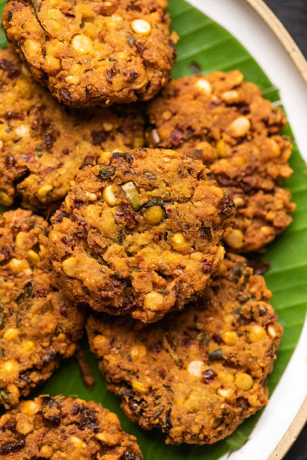 Closeup of a single masala vada to show the crispy texture and dots of fried chana dal on it