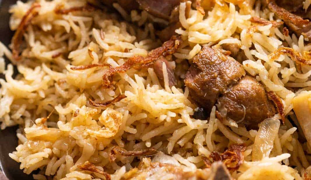 Closeup of yakhni pulao to show the texture of rice and mutton pieces