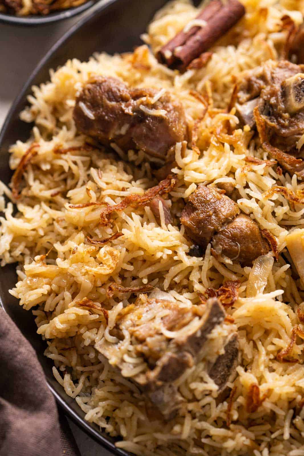 Closeup of yakhni pulao to show the texture of rice and mutton pieces