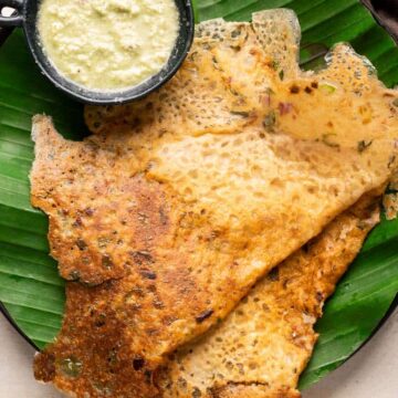Instant oats dosas served on a banana leaf lined plates with coconut chutney