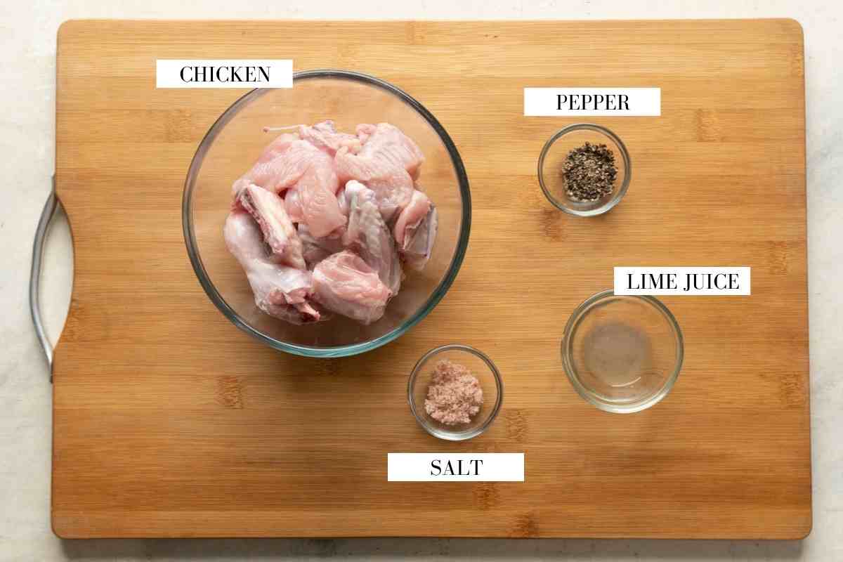 Ingredients for marinating chicken kali mirch on a brown board with text to identify them