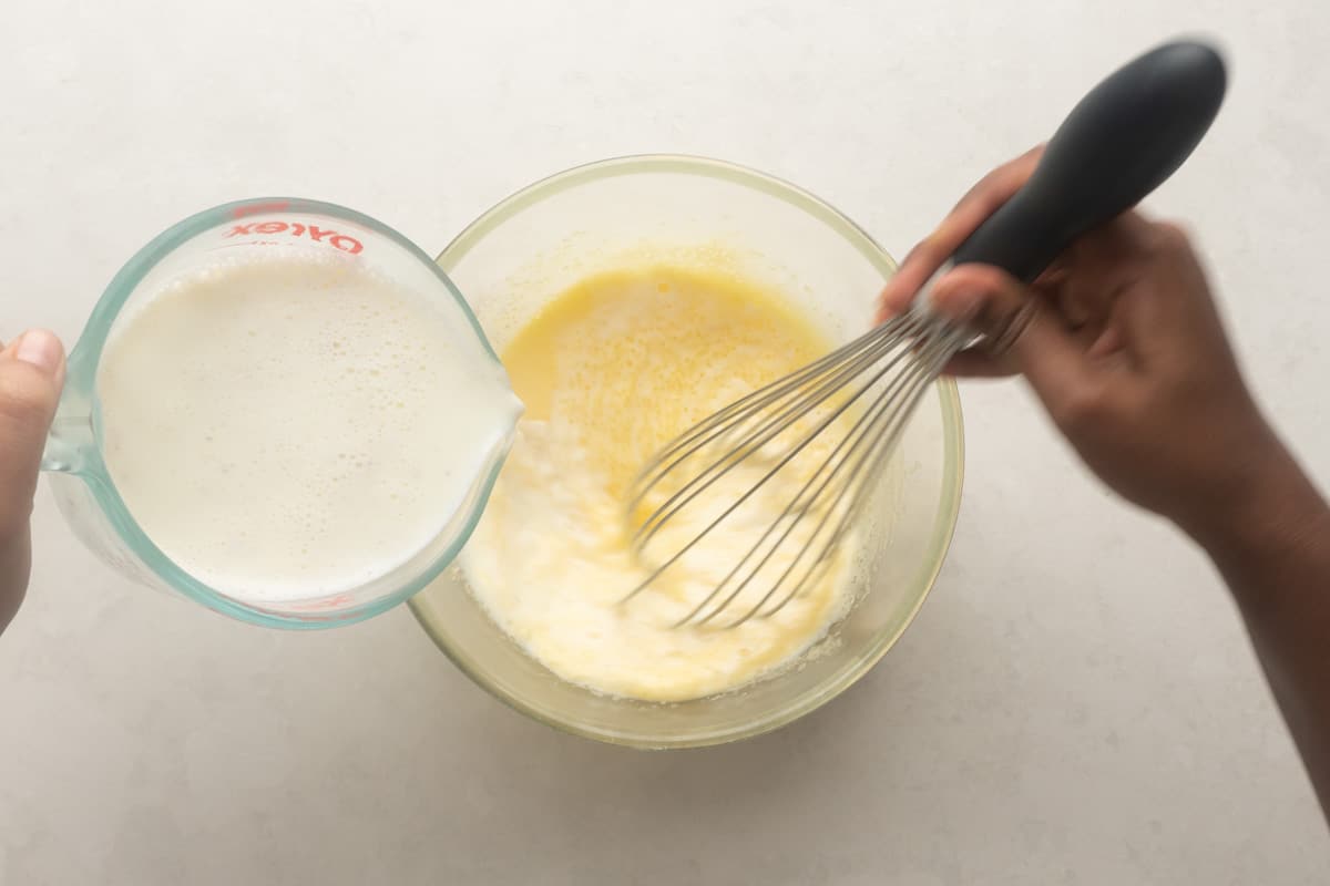Picture showing how to temper yolks with milk