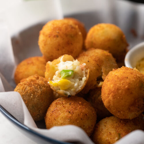 Closeup of a bite of cheese balls to show the cheesy center