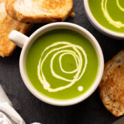 Spinach Soup served in a bowl with toasted bread on the side