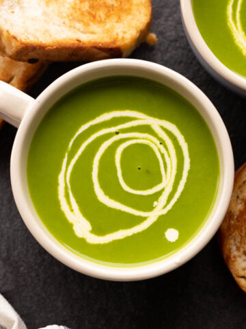 Spinach Soup served in a bowl with toasted bread on the side