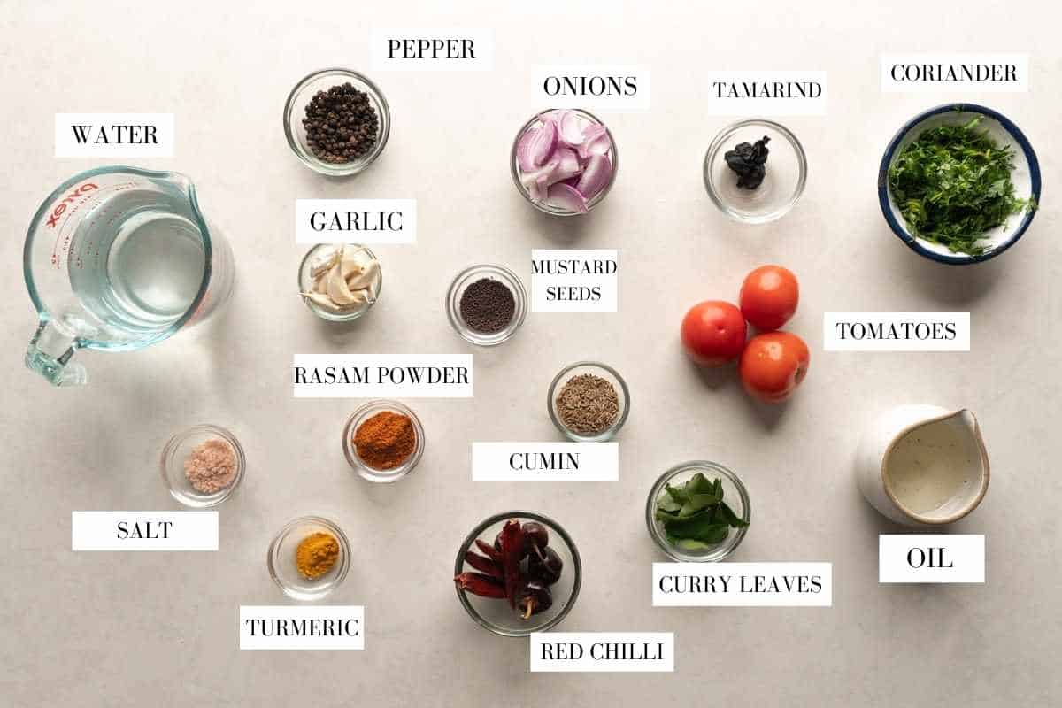 Picture of all the ingredients required for making tomato rasam with text to identify them