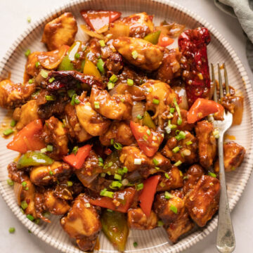 Szechuan Chicken served on a white plate with a fork