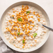 Boondi Raita served in a white bowl with coriander on top