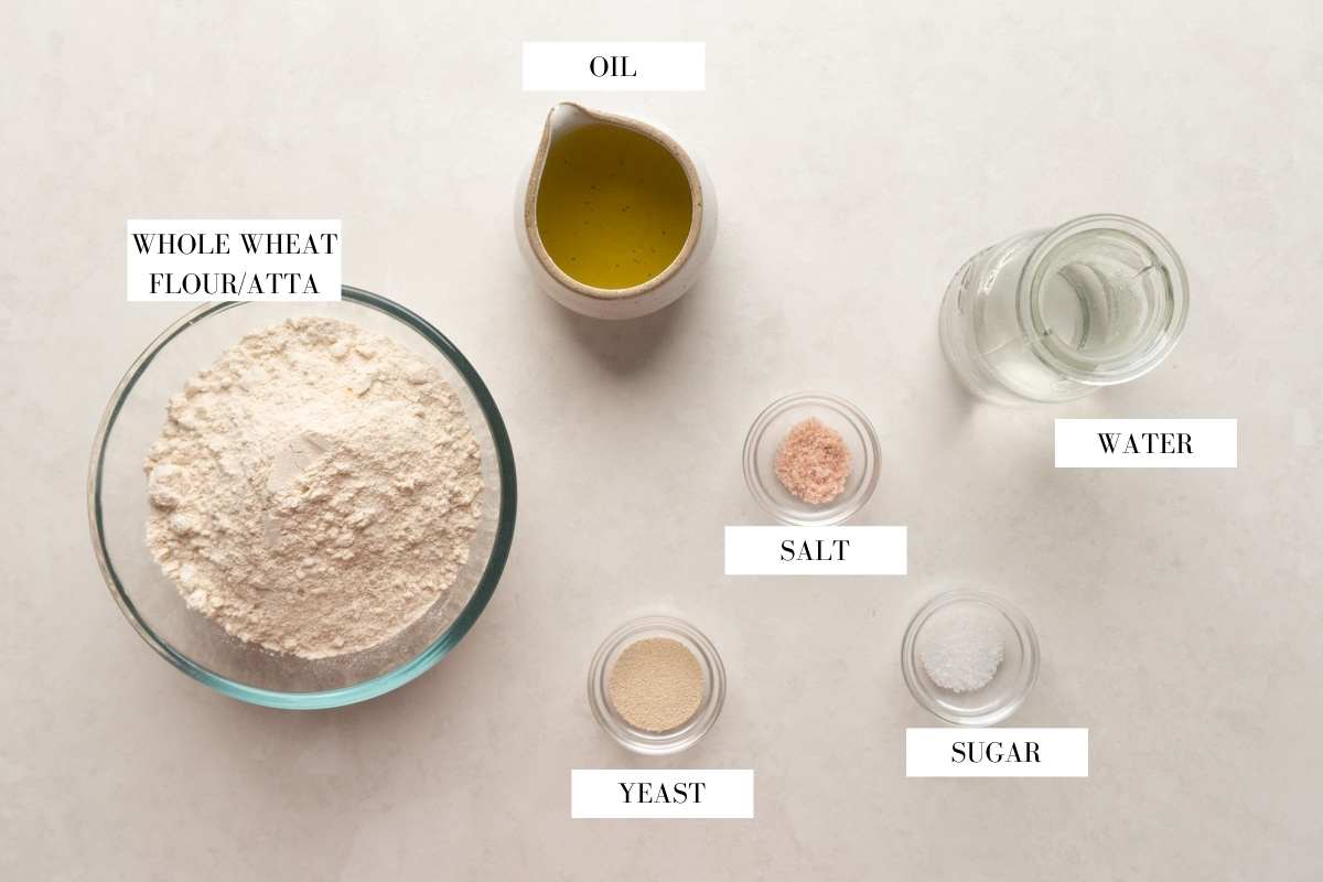Picture of all the ingredients required for whole wheat pita bread with text to identify them