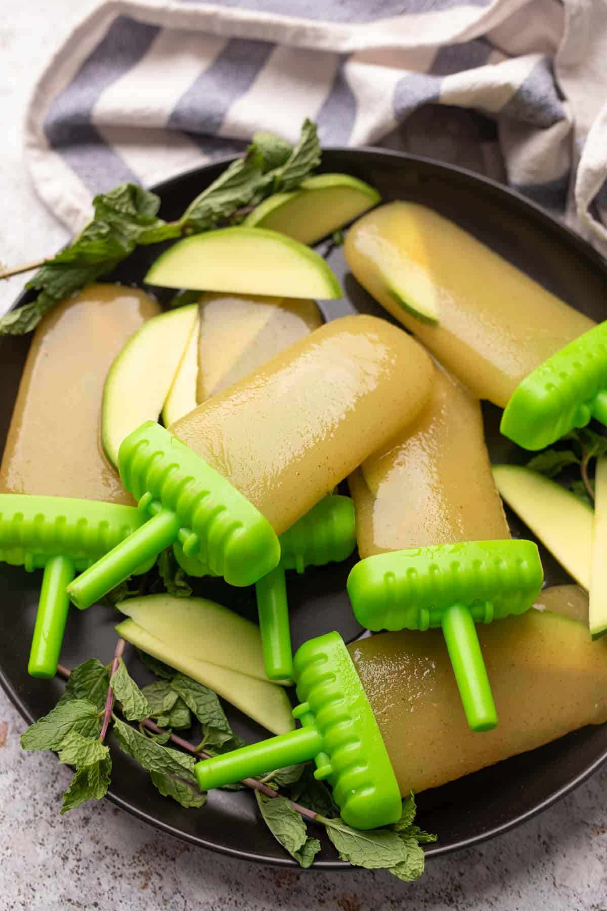 Aam Panna popsicles served on a black plate