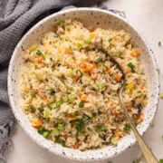 Picture of fried rice in a white bowl with a spoon