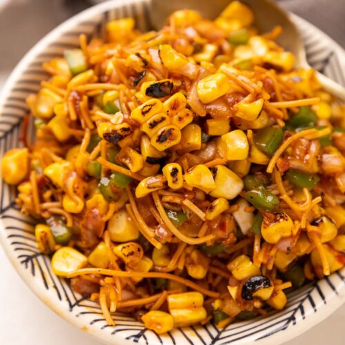 Corn Bhel served in a cowl with a spoon on the side