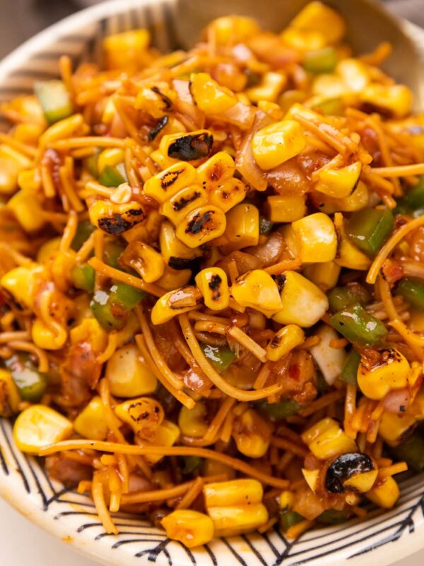 Corn Bhel served in a cowl with a spoon on the side