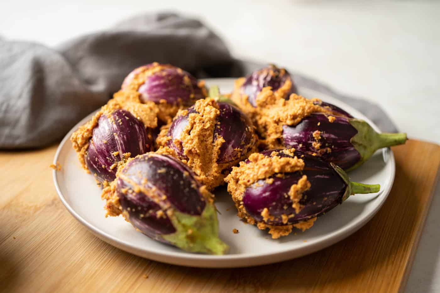 Picture of stuffed brinjals on a plate ready to be widow to the curry