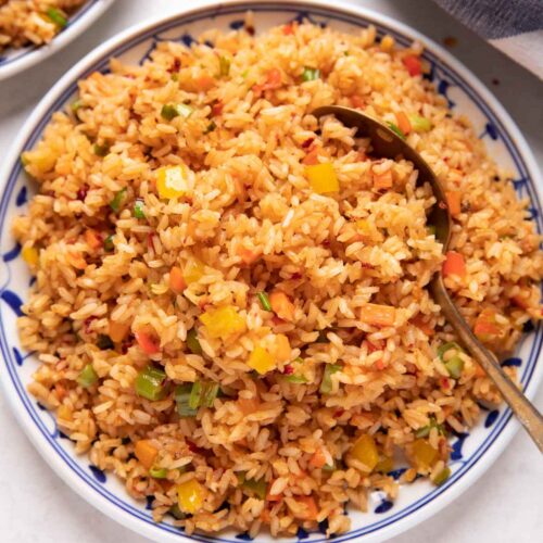 Picture of chilli garlic fried rice served on a white and blue plate