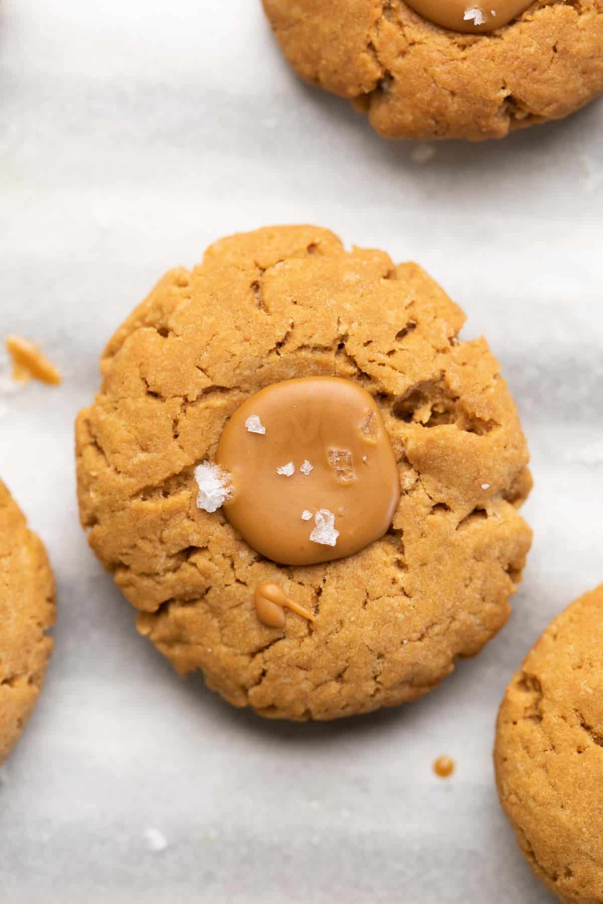 A shot of a biscoff thumbprint cookie with sea salt sprinkled on top.