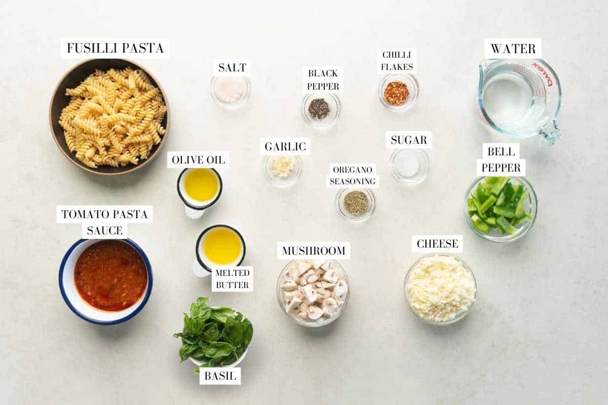Picture of all the ingredients required for the air fryer baked pasta with text to identify them