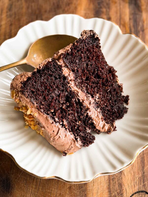 a slice of the one bowl chocolate cake served on a white dish with a spoon