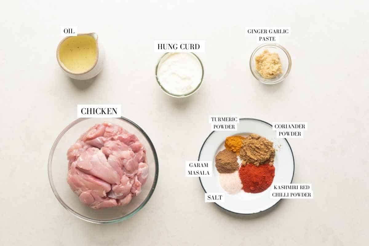 Picture of all the ingredients for Instant Pot Chicken Tikka Masala with text to identify them