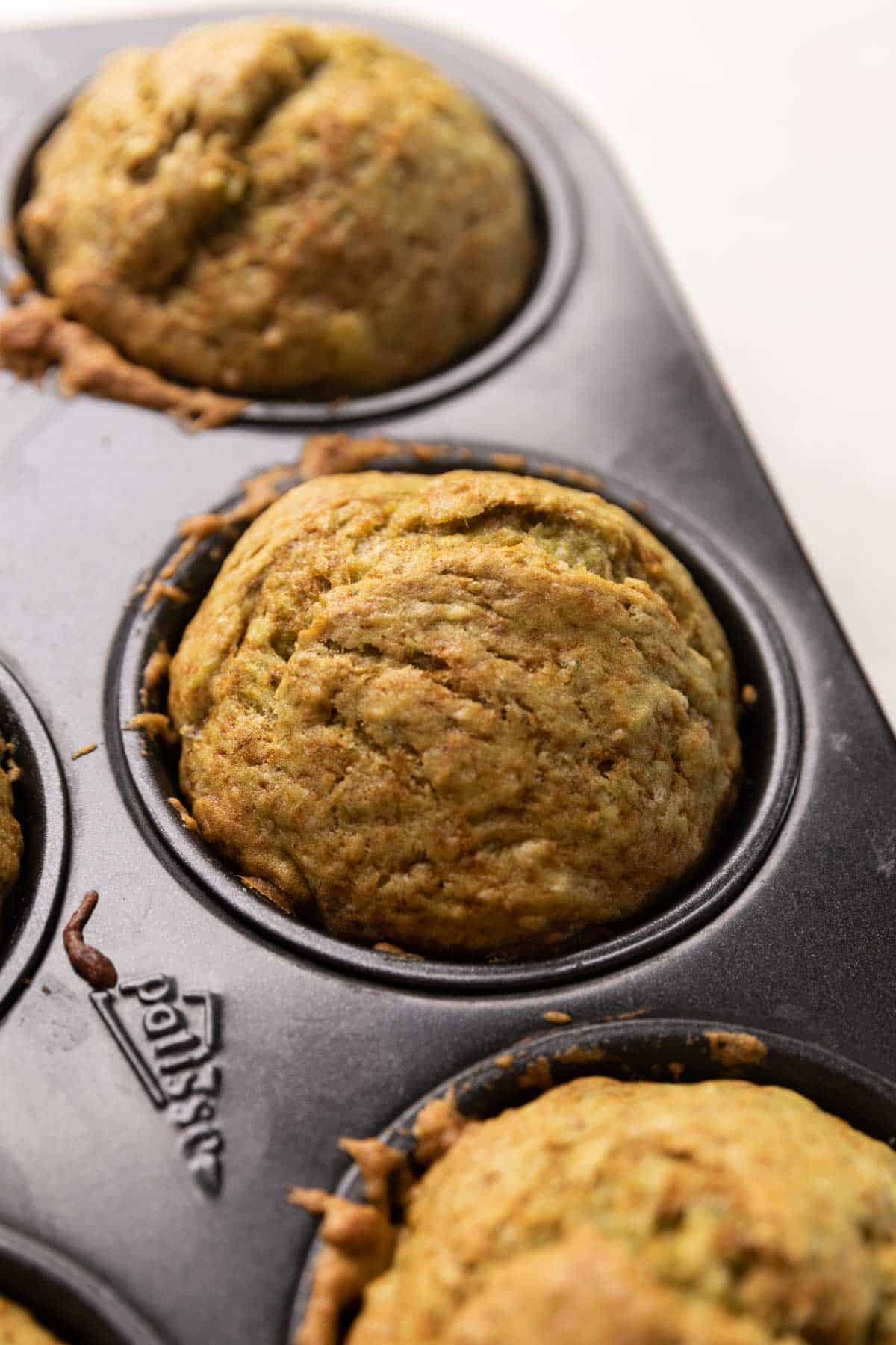 close up shot of green banana muffin in the baking tin