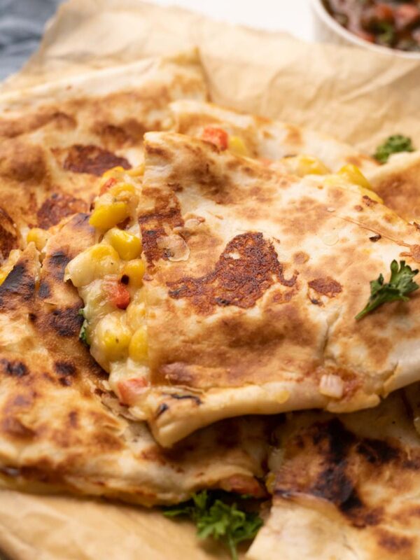 bell pepper corn and cheese quesadilla with crispy bits of cheese with a side of tomato salsa