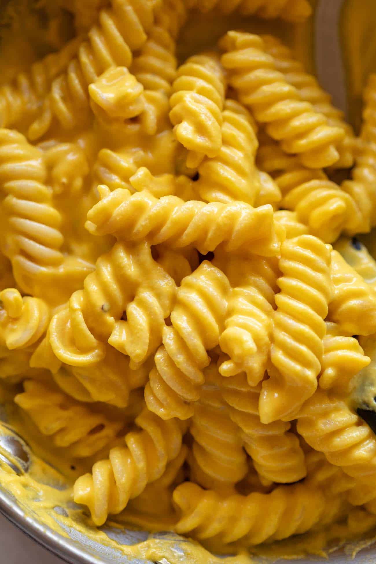 Close up of carrot pasta to show the creammy texture