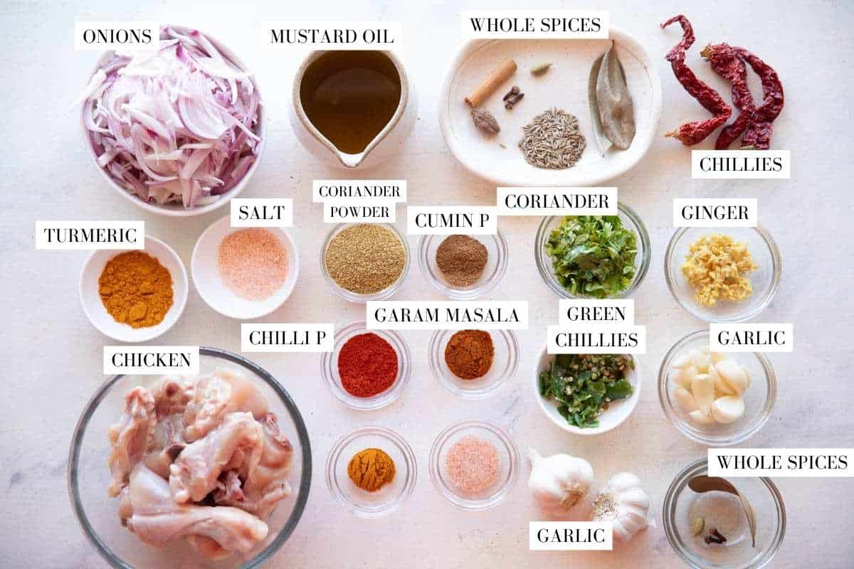 Picture of all the ingredients required for bihari chicken curry with text overlay to identify them