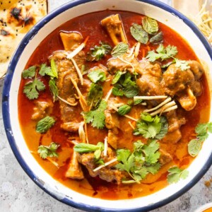 mutton nihari served on a bowl and garnished with coriander and julienned ginger