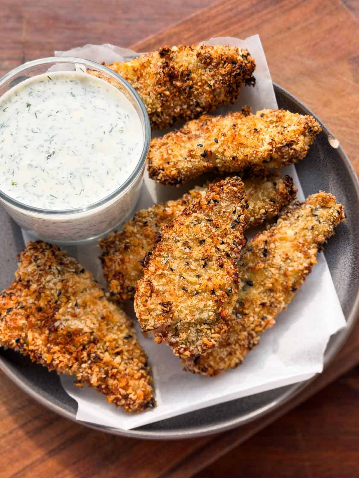 Air Fryer Chicken Tenders served in a grey plate with dill yogurt dip
