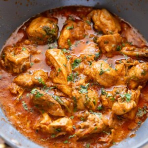 Closeup picture of dahi chicken in a kadhai that it was cooked in