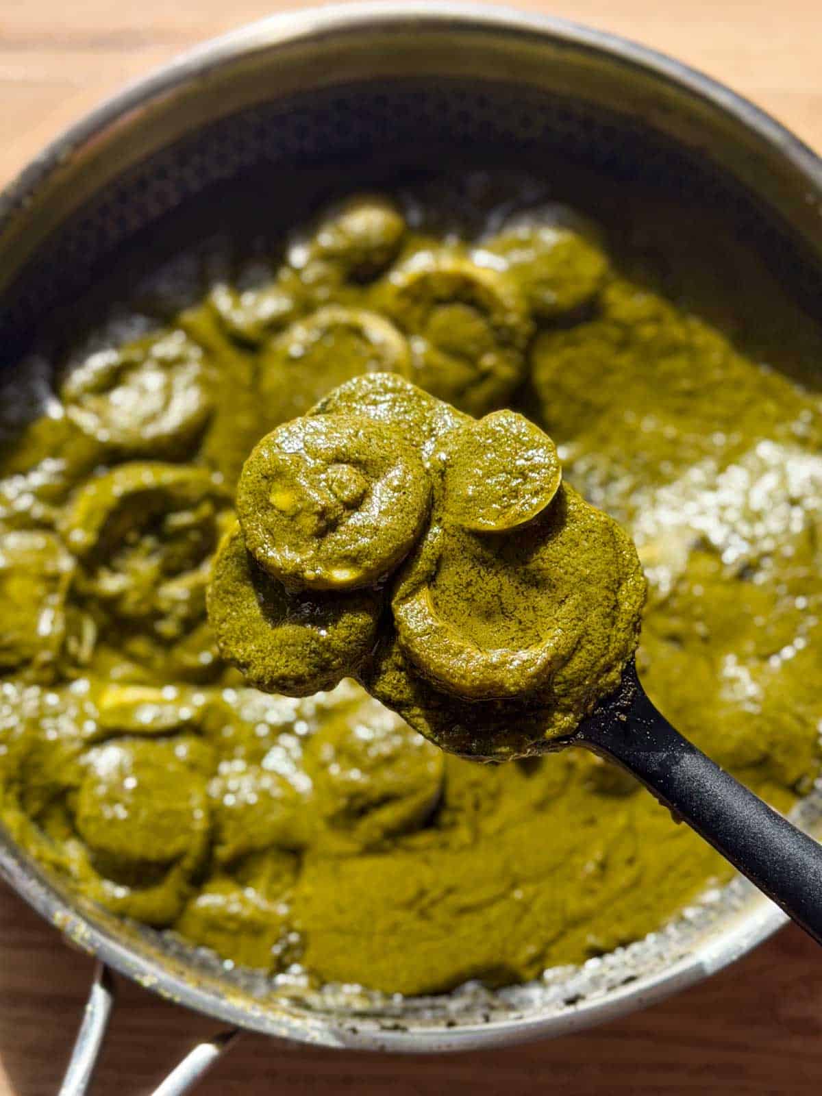 green egg curry in it's cooking vessel ready for serving