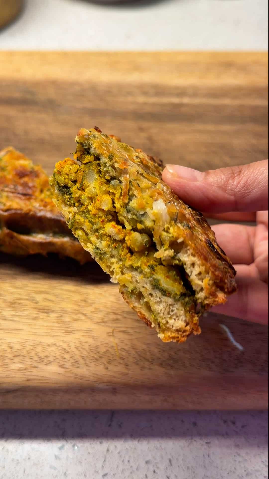 an air fryer bread pakora cut in half to show it's filling