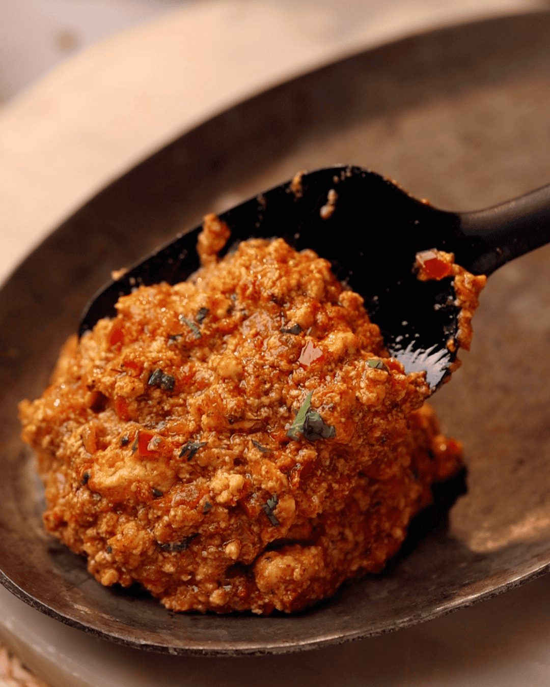 Amritsari paneer bhurji being served on a plate with a ladle