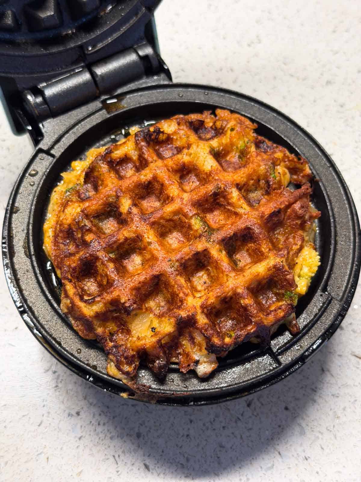 crispy potato waffle still in the waffle maker