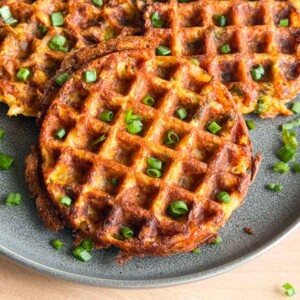 a bunch of crispy potato waffles served on a plate